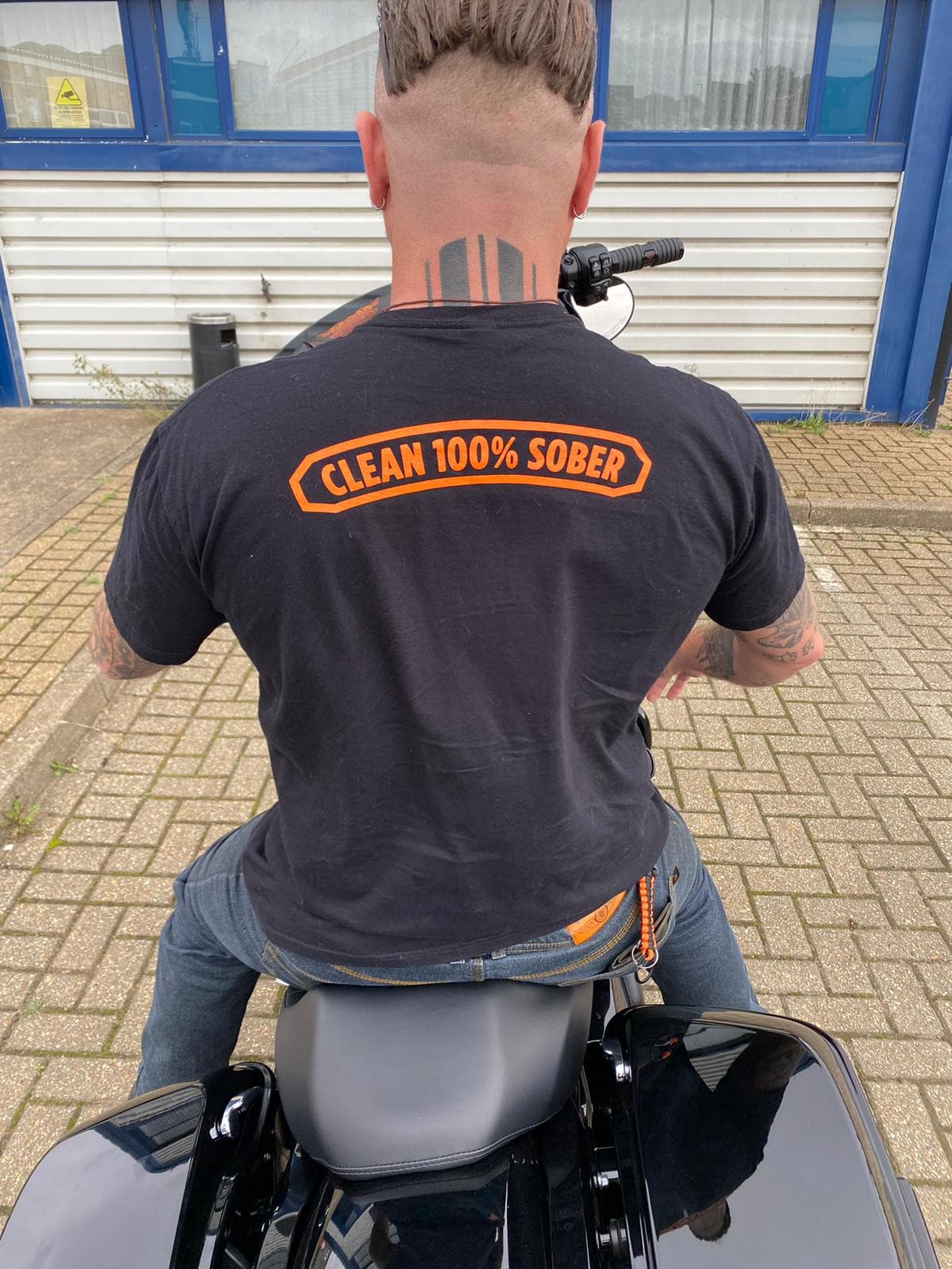 One of our members on a motorcycle, repping our "Clean 100% Sober" t-shirt.